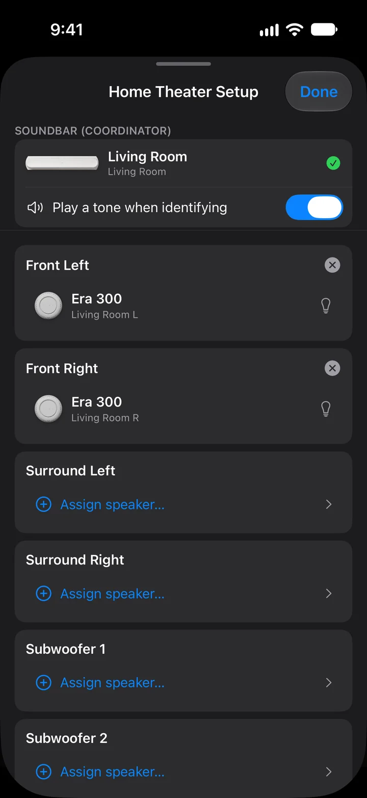 The Home Theater Setup sheet in dark mode: an Arc listed as the soundbar coordinator for Living Room, a Play a tone when identifying switch, Era 300 speakers assigned to Front Left and Front Right, and Assign speaker rows for Surround Left, Surround Right, Subwoofer 1 and Subwoofer 2.