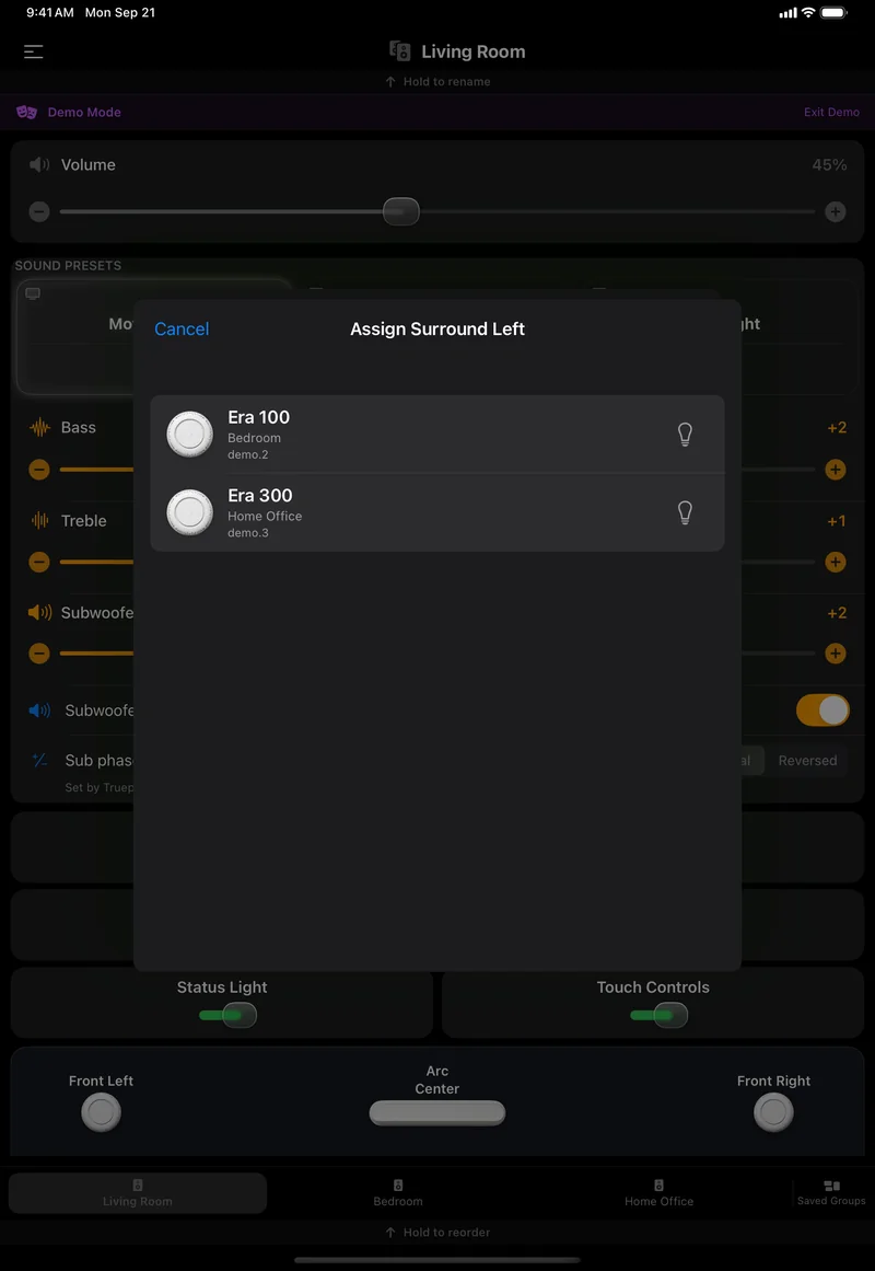 The Assign Surround Left picker on an iPad: two rows, Era 100 in Bedroom and Era 300 in Home Office, each with a bulb button, and Cancel.