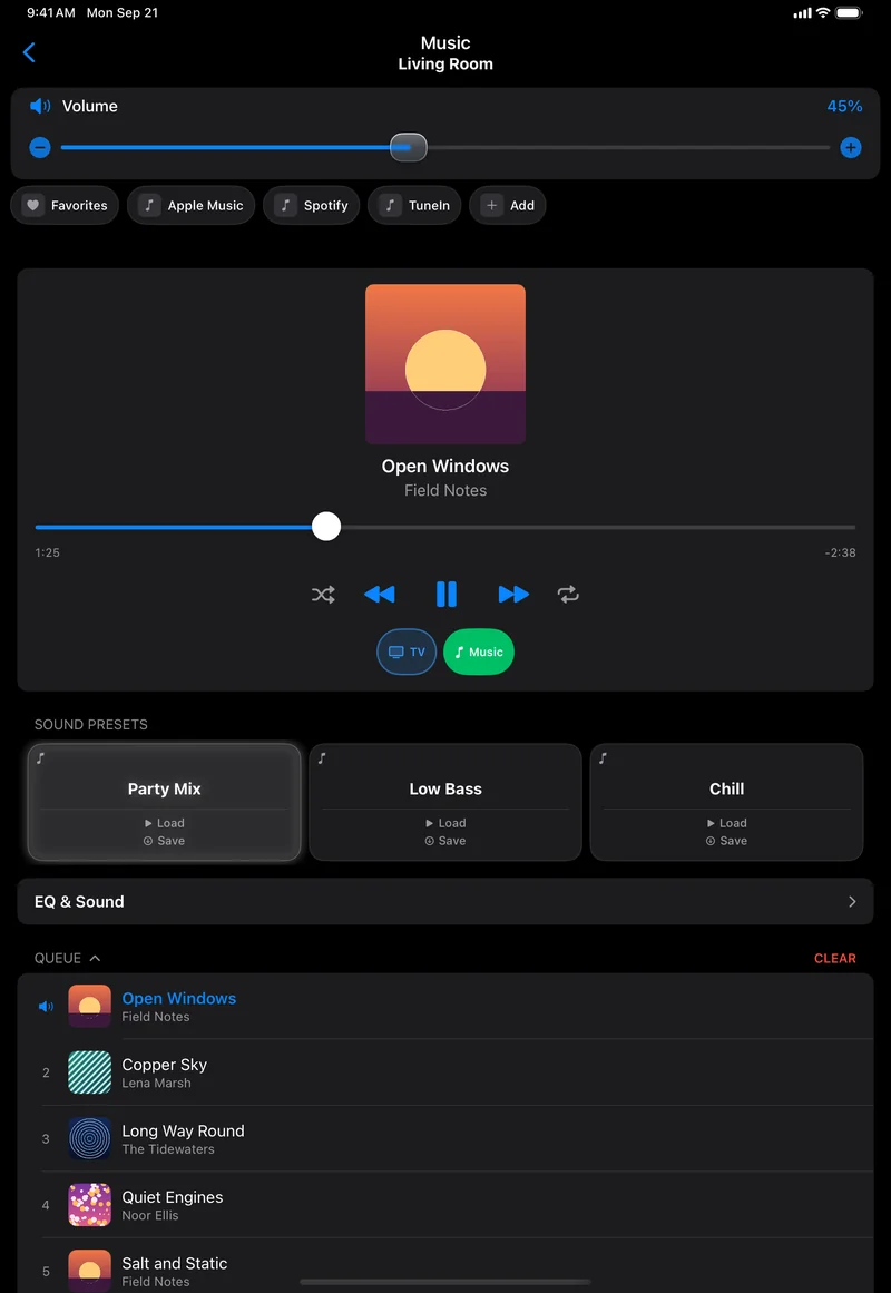 The Music page on an iPad in dark mode: Volume 45%, a strip reading Favorites, Apple Music, Spotify, TuneIn and Add, a player card with an orange sunset cover, Open Windows by Field Notes, a progress bar at 1:25 of 2:38 remaining, transport buttons, TV and Music with Music lit, Party Mix, Low Bass and Chill presets with Party Mix lit, an EQ and Sound row, and a Queue whose first five songs each carry a cover.
